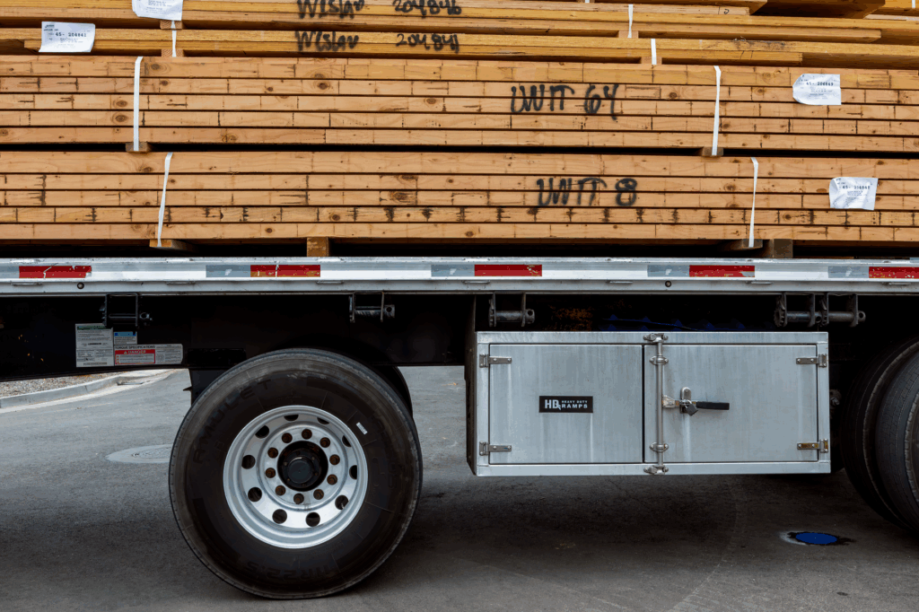 Tiny house being loaded onto a flatbed trailer by a professional moving company