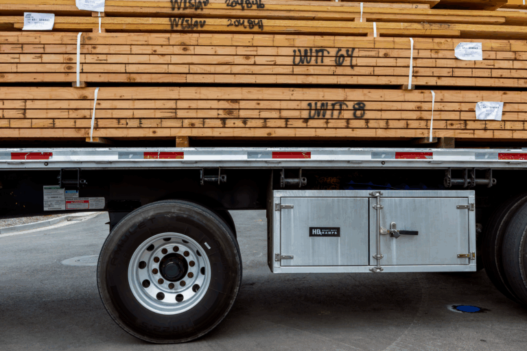 Tiny house being loaded onto a flatbed trailer by a professional moving company