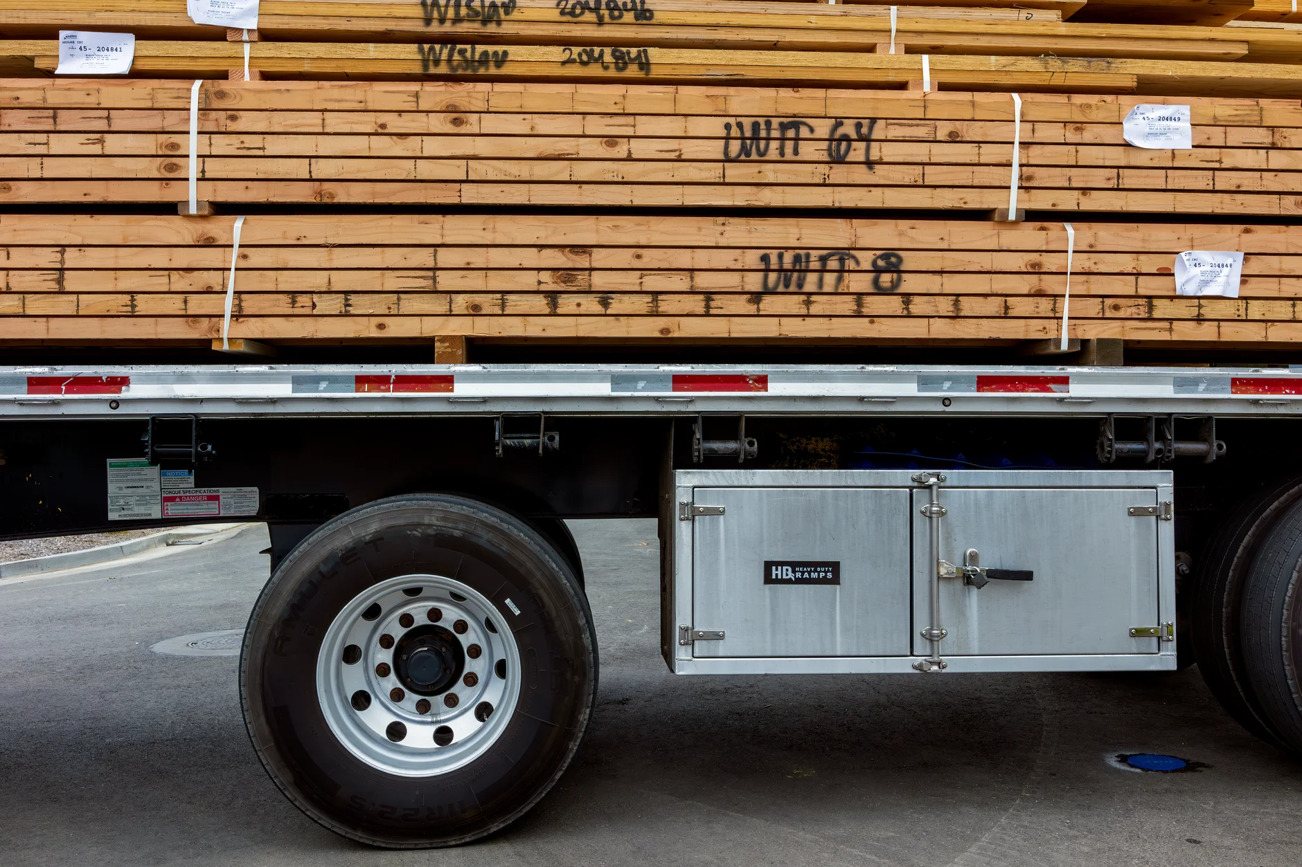 Tiny house being loaded onto a flatbed trailer by a professional moving company